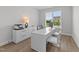 Bright home office with a large window, white desk, and ample storage, ideal for productivity at 1319 Richfield Oaks Dr, Fuquay Varina, NC 27526