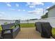 Backyard features patio with bench seating, a grilling area, lush lawn, and white fence surround at 140 Big Barn Dr, Wendell, NC 27591