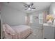 Well-lit bedroom with ceiling fan, plush carpet, and window with natural light at 140 Big Barn Dr, Wendell, NC 27591