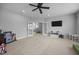 This large bonus room features carpeted floors, a ceiling fan, a tv, and double doors at 140 Big Barn Dr, Wendell, NC 27591