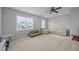 This bonus room features carpet floors, big windows, and a white sofa and loveseat at 140 Big Barn Dr, Wendell, NC 27591