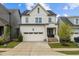 Charming two-story home with white siding, an attached garage, and a beautifully landscaped front yard at 140 Big Barn Dr, Wendell, NC 27591