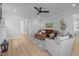 Inviting living room featuring hardwood floors, recessed lighting, neutral paint colors, and ceiling fan at 140 Big Barn Dr, Wendell, NC 27591