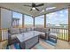 Spacious screened-in porch featuring comfortable seating, a ceiling fan, and views of the backyard and neighborhood at 140 Big Barn Dr, Wendell, NC 27591