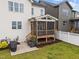 Cozy screened porch with wooden beams and access to a backyard at 140 Big Barn Dr, Wendell, NC 27591
