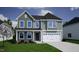 Charming two-story home with a two-car garage and manicured front lawn at 140 Cordoba Dr, Franklinton, NC 27525