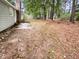 Large, level backyard with mature trees, and a concrete patio; great for entertaining at 1508 Hodge Rd, Knightdale, NC 27545