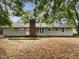 Back exterior of house with an expansive lot surrounded by mature trees at 1508 Hodge Rd, Knightdale, NC 27545