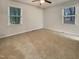 This bedroom has neutral carpeting, and large windows providing an abundance of natural light at 1508 Hodge Rd, Knightdale, NC 27545