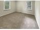 Bright bedroom with two windows offering plenty of natural light and neutral colored carpet at 1508 Hodge Rd, Knightdale, NC 27545