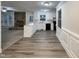 Open kitchen design with white cabinets, stainless appliances, and hardwood flooring adjacent to living area at 1508 Hodge Rd, Knightdale, NC 27545