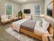 Cozy staged bedroom with neutral walls, light wood furniture, and great natural light at 1508 Hodge Rd, Knightdale, NC 27545