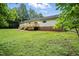 Large backyard with lush lawn and wooded perimeter at 160 Deer Tracks Dr, Wendell, NC 27591