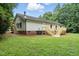 View of home's backyard with wooden decks and wooded surroundings at 160 Deer Tracks Dr, Wendell, NC 27591
