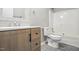 Bathroom showcasing a wood-look vanity, a white tiled shower, and modern fixtures at 160 Deer Tracks Dr, Wendell, NC 27591