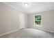 Cozy bedroom with a neutral carpet, light gray walls, and a bright window view at 160 Deer Tracks Dr, Wendell, NC 27591