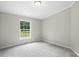 Comfortable bedroom with a large window, gray walls, neutral carpet, and natural light at 160 Deer Tracks Dr, Wendell, NC 27591