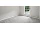 Neutral bedroom featuring gray walls, modern carpeting, and a bright window at 160 Deer Tracks Dr, Wendell, NC 27591