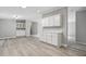 Open concept dining area with white cabinets, gray walls, and modern wood-look flooring at 160 Deer Tracks Dr, Wendell, NC 27591
