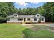 Well-maintained single-story home with a welcoming front deck, perfect for relaxing outdoors in a green yard at 160 Deer Tracks Dr, Wendell, NC 27591