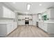 Modern kitchen with stainless steel appliances, updated cabinets, and wood-look flooring at 160 Deer Tracks Dr, Wendell, NC 27591