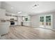 Bright and modern kitchen with white cabinetry, stainless steel appliances, and views to the backyard at 160 Deer Tracks Dr, Wendell, NC 27591