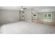 A spacious living room featuring plush carpeting, fresh neutral paint, and seamless flow into the kitchen at 160 Deer Tracks Dr, Wendell, NC 27591