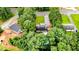 Aerial view of the home surrounded by lush trees with a pool on the property at 1605 Goldsboro Ave, Sanford, NC 27330
