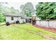 Spacious backyard with a pool, grassy area, and deck, perfect for entertaining and relaxation at 1605 Goldsboro Ave, Sanford, NC 27330