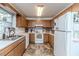 Efficient kitchen with white appliances, tile backsplash, and abundant wood cabinetry at 1605 Goldsboro Ave, Sanford, NC 27330
