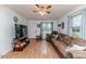 Inviting living room with hardwood floors, neutral walls and large windows at 1605 Goldsboro Ave, Sanford, NC 27330