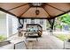 Outdoor patio under gazebo with furniture, potted plants, and patterned concrete, creating a relaxing retreat at 1605 Goldsboro Ave, Sanford, NC 27330