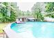 Refreshing pool area with lounge float and outdoor setting, complemented by lush greenery and backyard view at 1605 Goldsboro Ave, Sanford, NC 27330