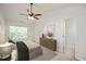 Calm bedroom featuring a ceiling fan, neutral decor, and ample natural light at 1642 Holly Grove Way, Durham, NC 27713