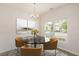 Bright dining area featuring a chandelier, artwork, and natural light from the large window at 1642 Holly Grove Way, Durham, NC 27713