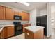 Kitchen featuring stainless steel appliances, light countertops and center island at 1642 Holly Grove Way, Durham, NC 27713