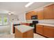 Kitchen featuring stainless steel appliances, light countertops and center island at 1642 Holly Grove Way, Durham, NC 27713