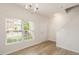 Bright living room featuring hardwood floors, a chandelier, and a large window at 1642 Holly Grove Way, Durham, NC 27713
