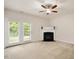Spacious living room featuring a fireplace, carpet, and glass doors to the outside at 1642 Holly Grove Way, Durham, NC 27713