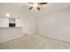 Bright living room featuring neutral carpet, a ceiling fan, and views of the adjacent kitchen at 1642 Holly Grove Way, Durham, NC 27713