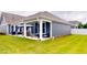 Relaxing back patio with a hammock, outdoor seating, and a view of the lush green backyard at 1720 Pinecliff Ct, Fuquay Varina, NC 27526
