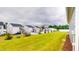 The backyard features a long green lawn between houses at 1720 Pinecliff Ct, Fuquay Varina, NC 27526