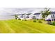 Expansive backyard showcasing a green lawn, privacy fence, and neighboring houses at 1720 Pinecliff Ct, Fuquay Varina, NC 27526
