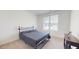 Inviting bedroom with neutral colors, a comfortable bed, and a large window for natural light at 1720 Pinecliff Ct, Fuquay Varina, NC 27526
