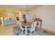 Dining area open to a modern kitchen featuring an island with seating and stainless steel appliances at 1720 Pinecliff Ct, Fuquay Varina, NC 27526
