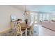 Bright dining room features a chandelier, oval table, buffet, and access to the backyard at 1720 Pinecliff Ct, Fuquay Varina, NC 27526