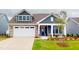 Beautiful two-story home with a manicured lawn, charming front porch, and stone accents on the garage at 1720 Pinecliff Ct, Fuquay Varina, NC 27526