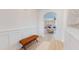 Bright foyer with light wood floors, white wainscoting, and an inviting view into the living area at 1720 Pinecliff Ct, Fuquay Varina, NC 27526