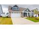 Beautiful home with stone details, a spacious two-car garage, and an inviting front porch at 1720 Pinecliff Ct, Fuquay Varina, NC 27526