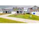 Attractive home boasting a two-car garage, pristine landscaping, and a cozy front sitting area at 1720 Pinecliff Ct, Fuquay Varina, NC 27526